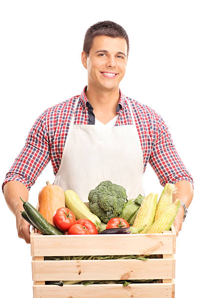 istock Man holding a wooden crate full of vegetables 489117724