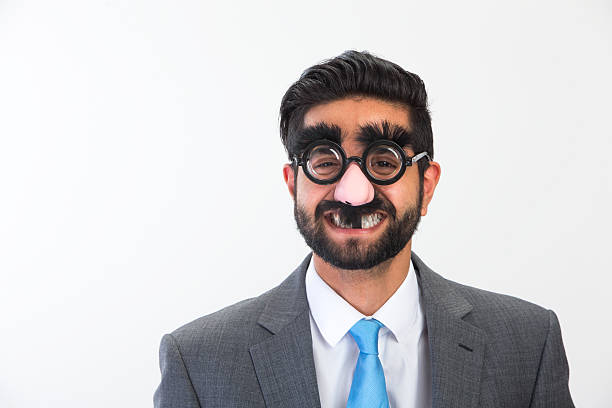Businessman in Disguise Businessman messing about wearing a funny mask groucho marx disguise stock pictures, royalty-free photos & images