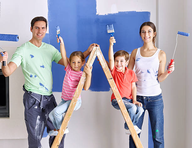 istock Family painting wall blue together 489118064