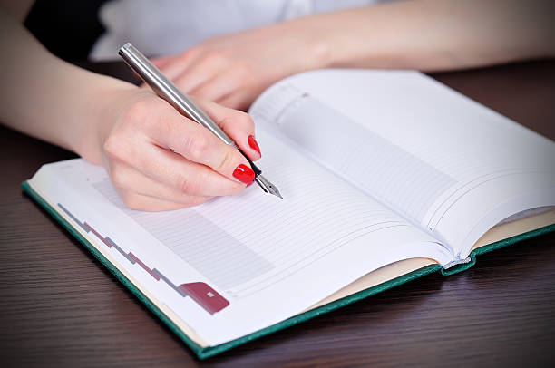 istock businesswoman writing 489118937