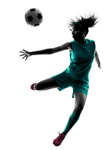 one teenager girl child  playing soccer player in silhouette isolated on white background