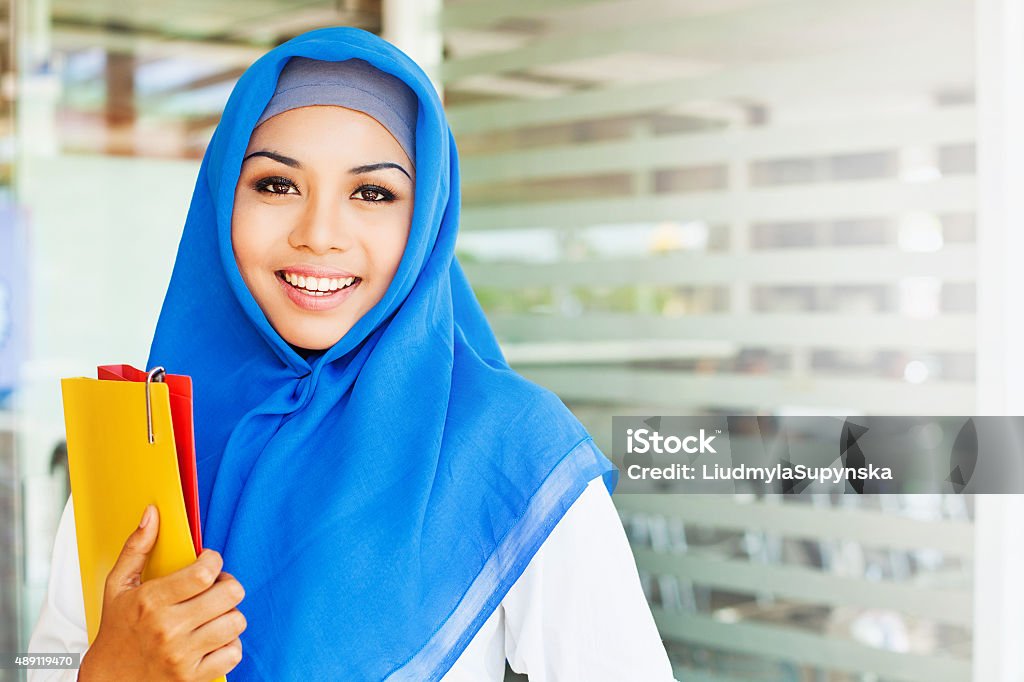 Muslim asian girl, a college student, in a class room Muslim women holding her workbooks Student Stock Photo