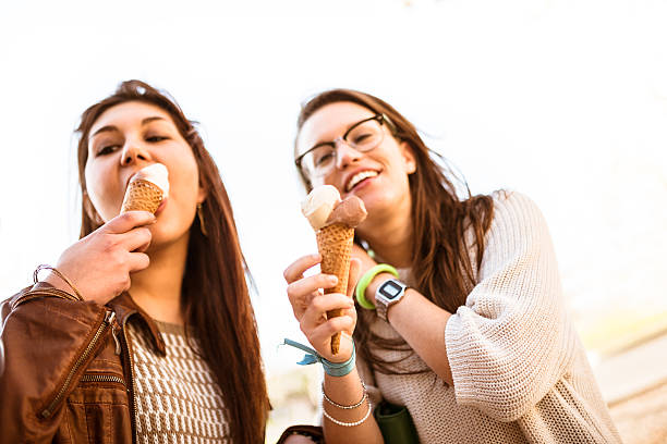 istock group of friends eating icecream on summer 489121013