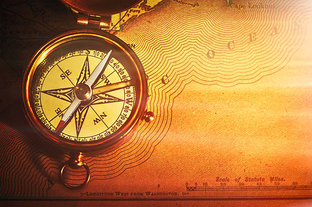 istock Antique brass compass over old USA map 489121052
