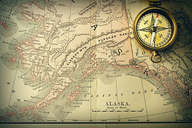 Antique brass compass over old XIX century map