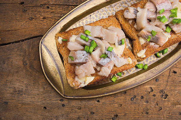istock toast with herring in antique tray on old wooden table 489123763