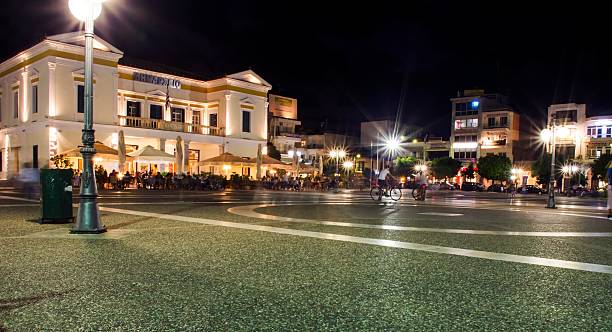 Sparta city centre A night view of the main square of the modern city of Sparta in Greece. On the left a view of the city Hall and some local shops and restaurants surrounding the square. gladiator shoe stock pictures, royalty-free photos & images