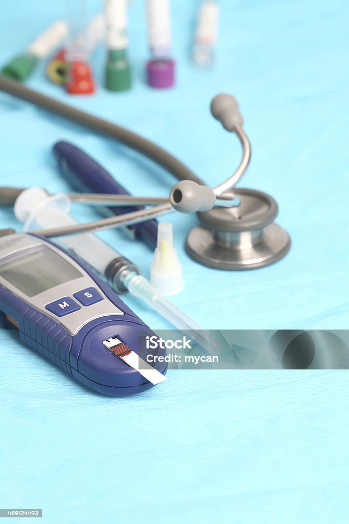 Diabetic is doing a glucose level finger blood test Analyzing Stock Photo