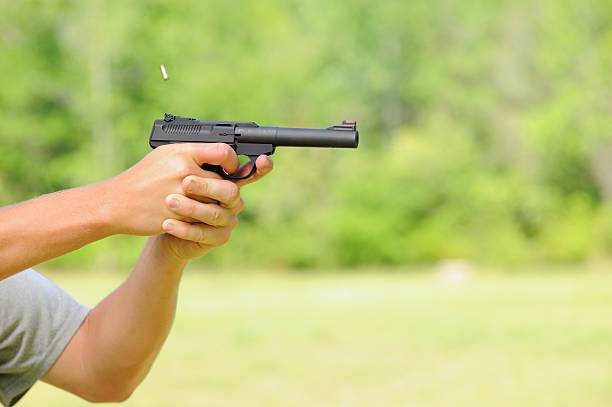 istock Firing gun with bullet cartridge ejecting 489125011