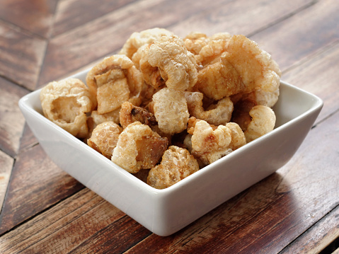 Close Up of Crispy Pork Rinds in a White Bowl