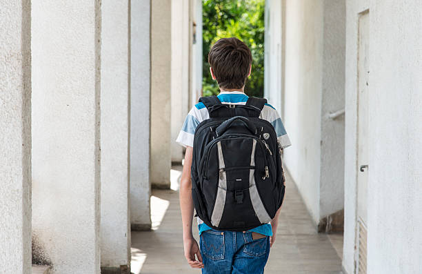istock Teenage school boy with a backpack walking to school 489139234