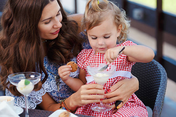istock Happy mom and daughter eating ice cream 489139944
