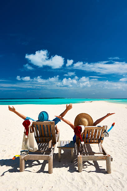 istock Couple relax on a beach at christmas 489140696