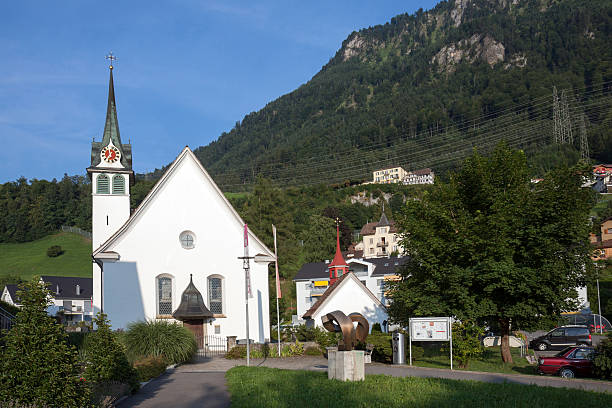 White church in Morschach in late afternoon light.