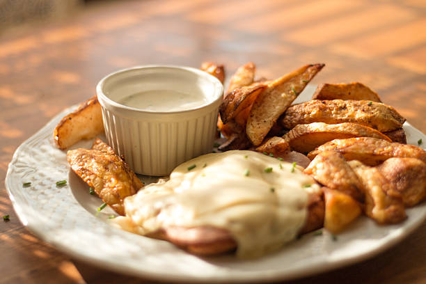 Fried potato wedges with white sauce and steak