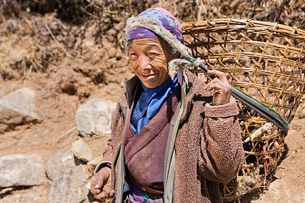 istock Old woman carrying basket 489147858