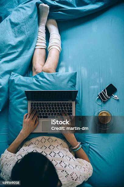 Girl In Bed With Lap Top Stock Photo - Download Image Now - Bed - Furniture, Laptop, Working At Home