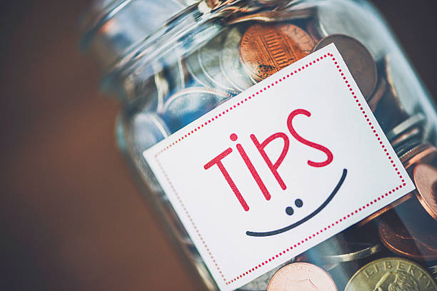 istock Tip jar with American currency on brown background 489149664
