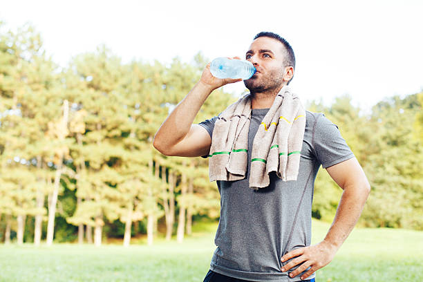 istock Young man drinking water from a bottle after workout 489153596