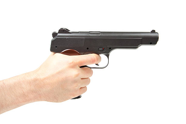 istock Man's hand holding gun, isolated on white 489169258