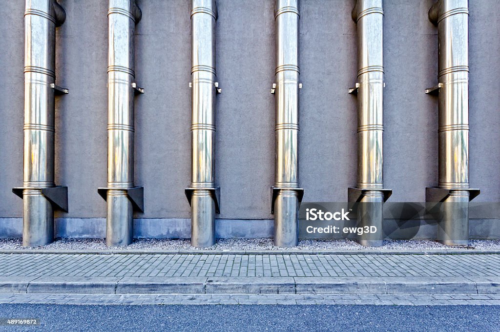 Metal pipes Facade of an industrial building with metal pipes. Engineering Stock Photo