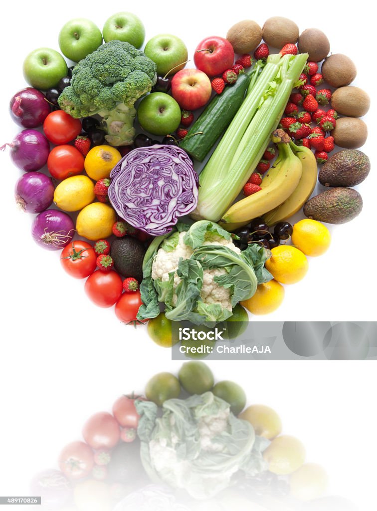 Heart shape fruit and vegetables Various fruits and vegetables in a heart shape over a white background 2015 Stock Photo