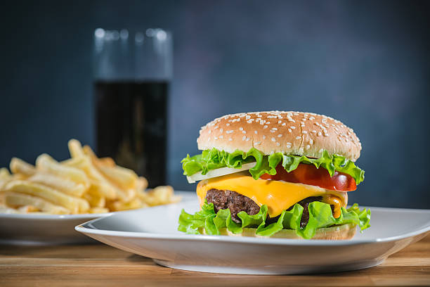 istock Burger served on a plate with fries and a Coke 489171026