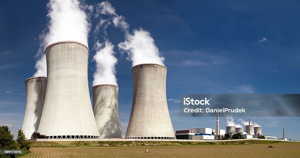 Nuclear power plant Dukovany - cooling towers Nuclear power plant Dukovany - cooling towers, field and beautiful sky - Czech Republic 2015 Stock Photo
