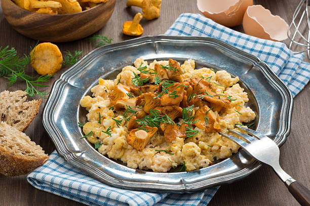 istock scrambled eggs with chanterelles and herbs on a plate 489173764