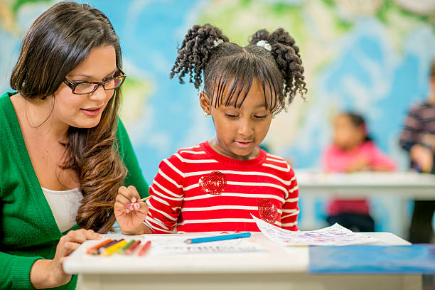 istock Little Girl Coloring at School 489175090