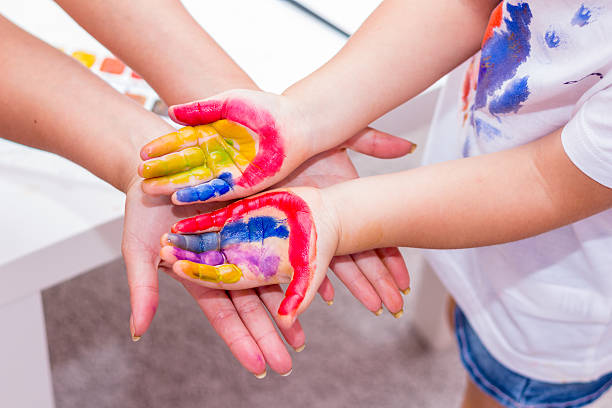 istock Hands of a child painted with bright colors. 489175218