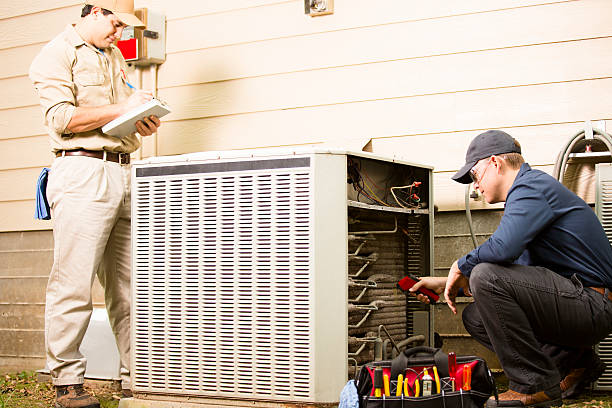 istock Air conditioner repairmen work on home unit. Blue collar workers. 489178364