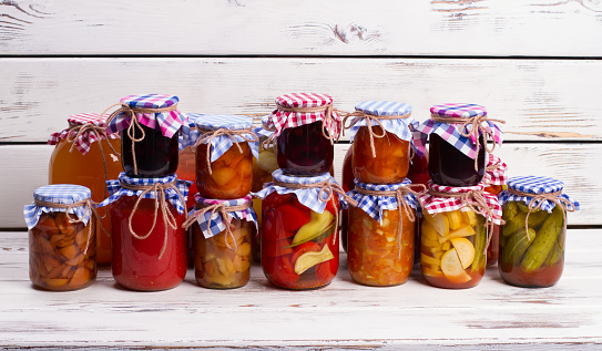 Three jars of fermented stuffed green bell peppers on a shelf