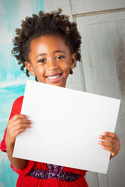 Beautiful Ethiopian child smiling while holding blank sign