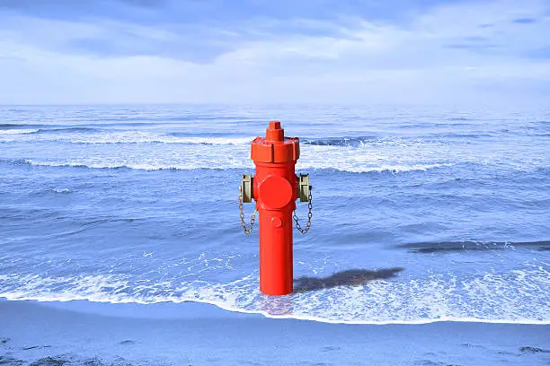 A hydrant at the seaside. Plenty of water: concept image - toned image