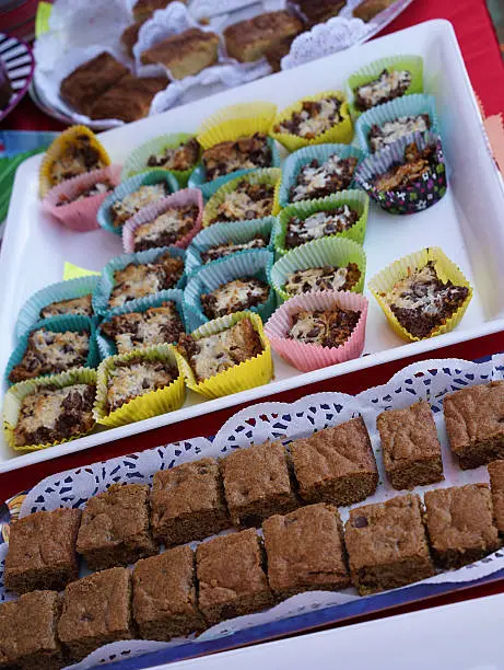 Colorful variety of baked goods and desserts on trays.