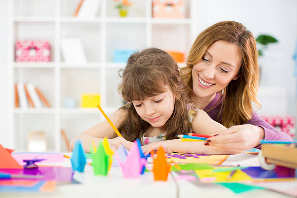 istock Mother and daughter making origami. 489189685