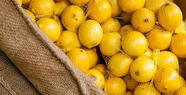 istock Bunches of Bagged Lemons in a Burlap Display 489190183