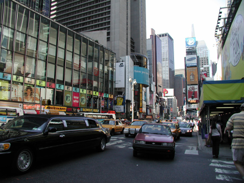 New York City, NY, USA - June 18, 2001: Limo and cabs head downtown. Pedestrians on right. MTV Studios, left. 