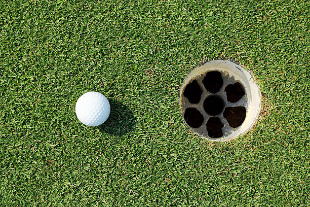 istock golf ball near the hole 489192323