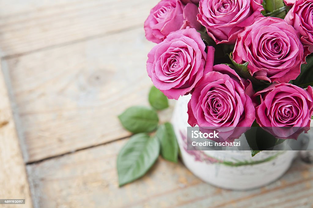 Beautiful roses Bouquet of beautiful pink roses on wooden background Anniversary Stock Photo