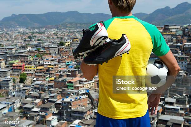 Brazilian Football Player In Brazil Kit Holding Soccer Ball Favela Stock Photo - Download Image Now