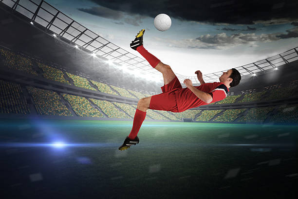istock Football player in red kicking 489194287