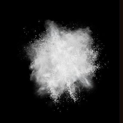 Explosión del polvo blanco aislado sobre fondo negro photo