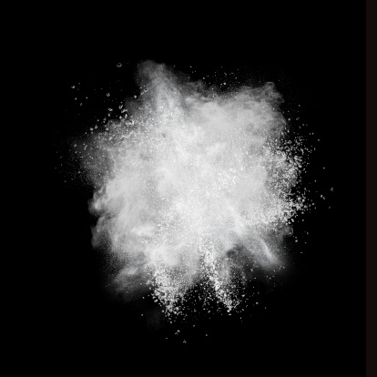 White powder explosion isolated on black background