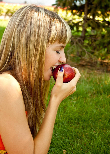 istock girl with red apple 489196449