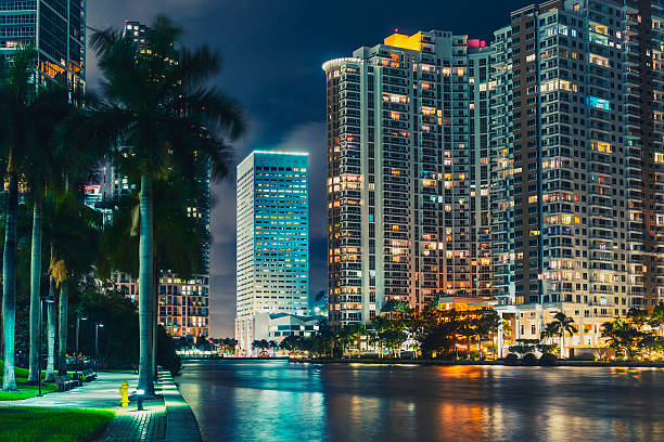 The Miami City Viewed from Miami River at Night The city of Miami, viewed from Miami River during a cloudy night of summer. cay photos stock pictures, royalty-free photos & images