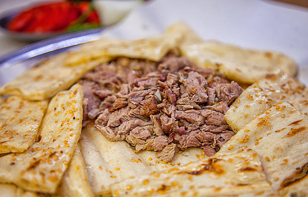 Traditional Denizli Kebabı Portion of traditional Turkish Denizli lamb kebab with pita and salad. have to eat with hands. denizli stock pictures, royalty-free photos & images