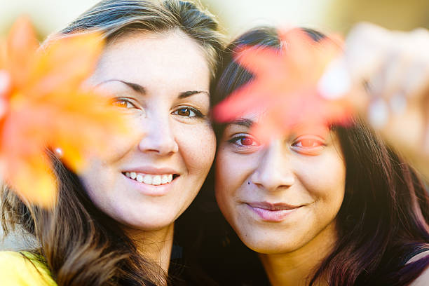Two mixed race women in Autumn garden