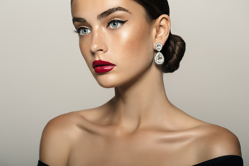 Portrait of a nice looking woman with beautiful earings. Professional make up